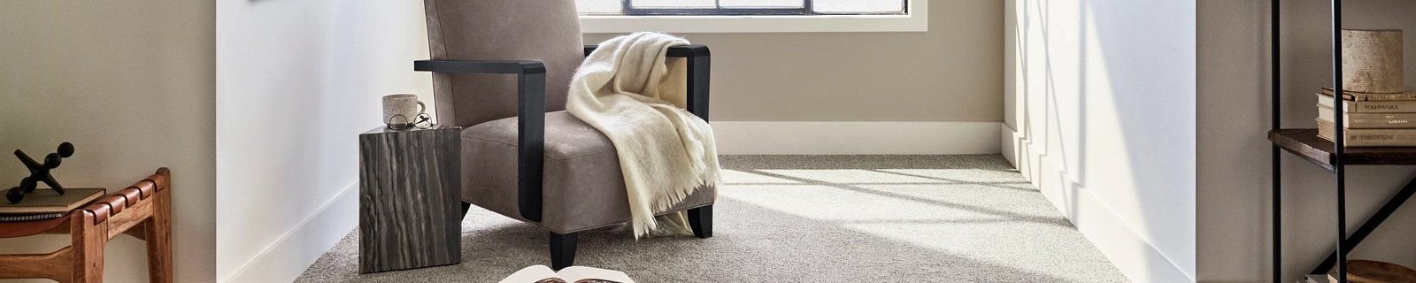 gray armchair next to a window in a room with white carpet floor from Richardson’s Carpet Service in the Williamsburg, VA area